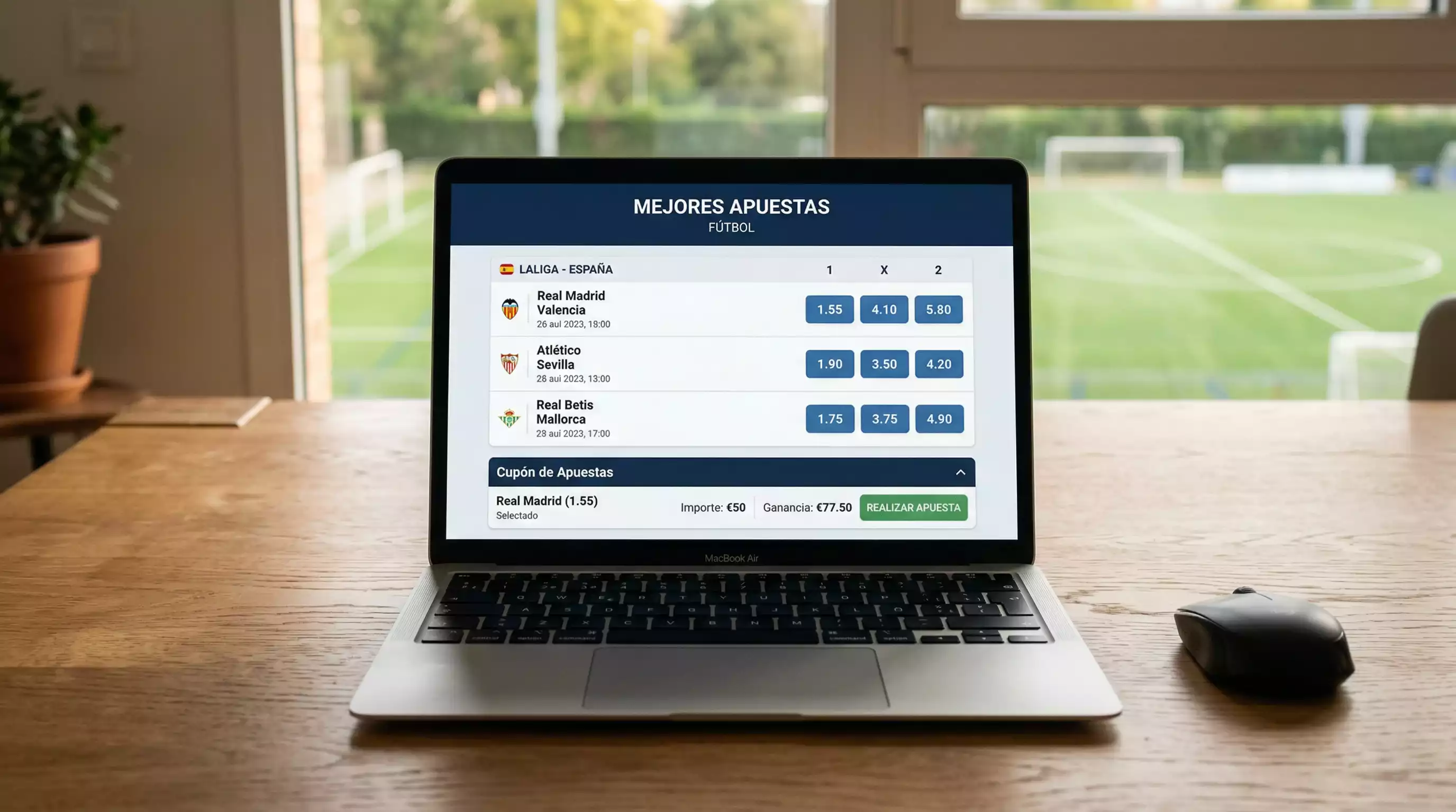 Pantalla de ordenador portatil mostrando una interfaz de apuestas deportivas con un campo de futbol al fondo